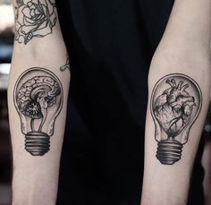 two tattoos on both arms, one with a heart and the other with a light bulb