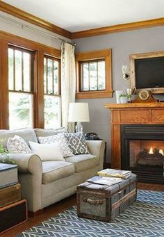 a living room filled with furniture and a fire place in front of a tv mounted on a wall