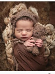 a baby is sleeping with a teddy bear