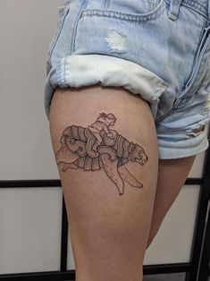 a woman with a tattoo on her thigh