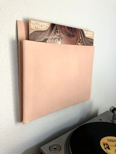 a record player with a vinyl album in its pocket on top of a turntable