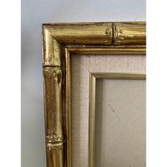 a gold frame with a bamboo stick sticking out of it