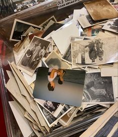 a pile of old photographs and pictures in a case