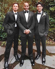 three men in tuxedos posing for a photo