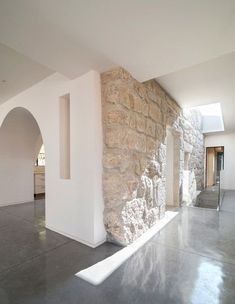 an empty room with stone walls and windows