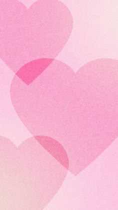 two pink hearts in the middle of a blurry background