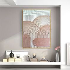 a white shelf topped with books and vases next to a painting on the wall