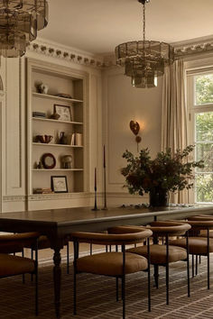 an elegant dining room with chairs and a table