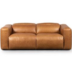 a brown leather couch sitting on top of a white floor