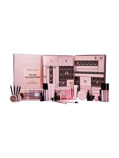 an assortment of cosmetics and makeup products displayed on a white surface with the contents labeled in pink