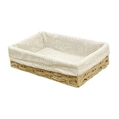 a wicker dog bed with white dots on the top and bottom, sitting in front of a white background