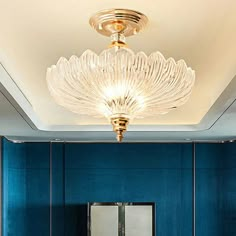 a bathroom with blue walls and a gold chandelier