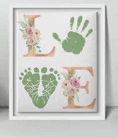 a white frame with flowers and hand prints on it