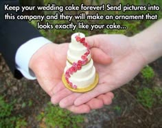 someone is holding a wedding cake in their hand