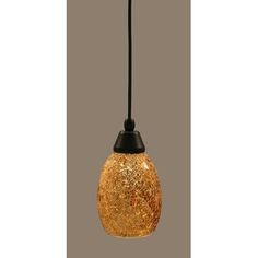 a gold glass light hanging from a black cord