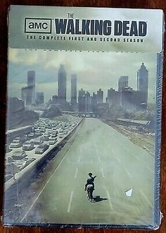 the walking dead dvd with an image of a man on a motorcycle in front of a city