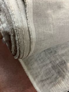 a piece of cloth is folded on top of the other fabric in front of it