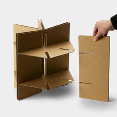 an open cardboard box being held by a hand