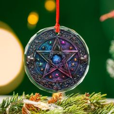 a glass ornament hanging from a christmas tree