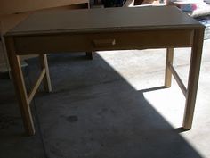 a wooden desk sitting in the middle of a room