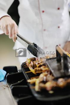 a chef is cooking food on the grill