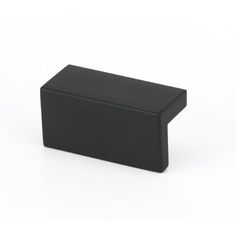 a black square object sitting on top of a white surface