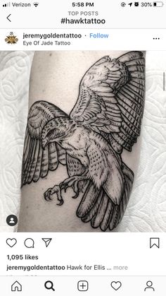 a black and white tattoo of an eagle with wings spread out, on the leg