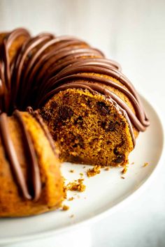 a bundt cake with chocolate frosting on a white plate