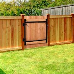 a wooden fence in the middle of a yard