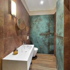 a bathroom with two sinks and a mirror in the wall above it, along with a shower stall