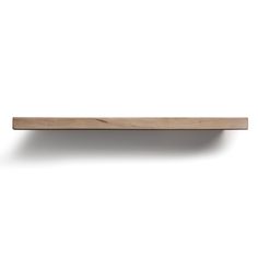 a wooden shelf on a white wall