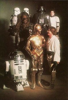 a group of star wars characters standing next to each other