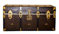 an old fashioned trunk with brass hardware and rivets on the sides, sitting upright