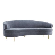 the curved sofa has gold legs on it