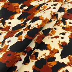 an orange and black paint splattered fabric