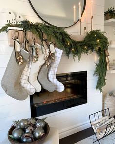 stockings hung on the mantle with christmas decorations