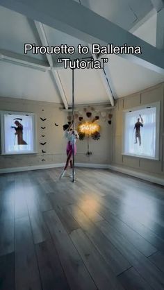 a woman is dancing on a pole in the middle of a room with two windows