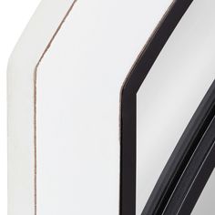 a close up view of the side of a white and black clock