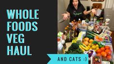 a woman standing in front of a table full of food and vegetables with the words whole foods veg haul