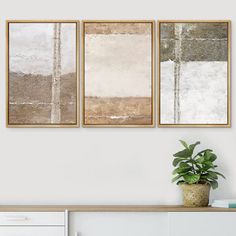 three paintings hanging on the wall above a white dresser with a potted plant next to it