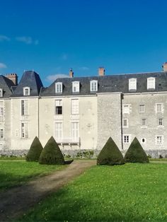 an old building with trees in front of it