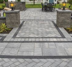 an outdoor patio with stone blocks and tables