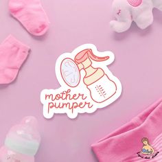 a mother pumper sticker sitting on top of a pink table next to her baby's pacifier