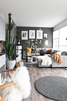 a living room filled with furniture and pictures on the wall