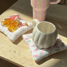 a cup and some candy on a table