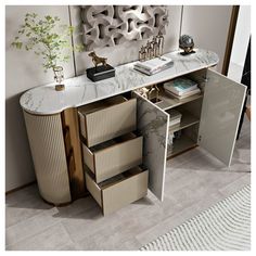 a white and gold sideboard with drawers in the corner next to a plant on a table