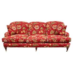 a red couch with floral designs on it