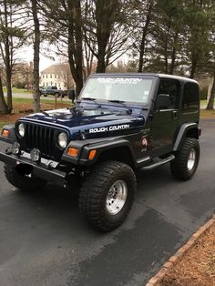 a black jeep is parked on the street