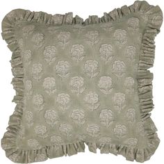 a decorative pillow with ruffled edges and flowers on the front, in light green