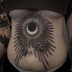 a woman's stomach with sun and clouds tattoo on her belly, which is decorated in black ink